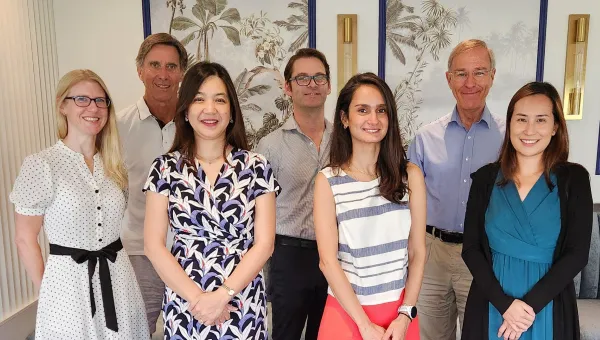 The NiPPeR study team, stood in a light and bright room. There are two rows with three men in the back and four women in the front.