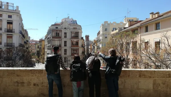 Beth and 3 of her fellow students, on a balcony looking out at Alicante buildings.