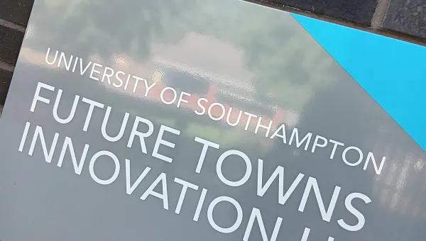 Sign reading "University of Southampton Future Towns Innovation Hub" on a brick wall.