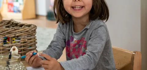 Early Years Centre child drawing at table