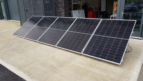 Solar panels on the floor at the entrance of a workshop