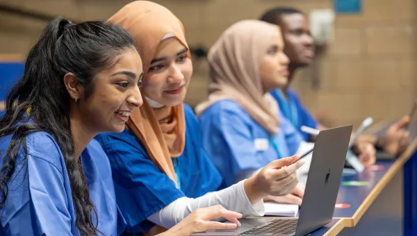 Fahmia and other student doctors sitting at laptops