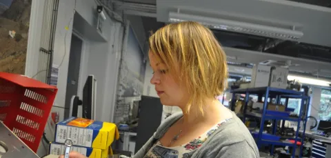 Dr Sarah Moller using tools in a workshop.