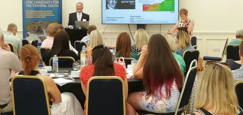 A person giving a presentation at the Renters' Rights event.