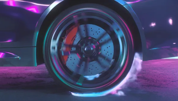 Close-up of a car wheel in motion, showing a spinning brake disc and caliper with visible brake dust and smoke.