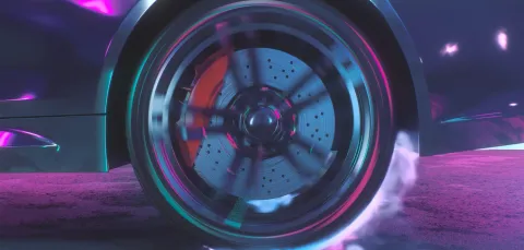 Close-up of a car wheel in motion, showing a spinning brake disc and caliper with visible brake dust and smoke.