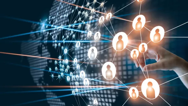 A hand interacting with a digital network of connected person icons over a world map background.