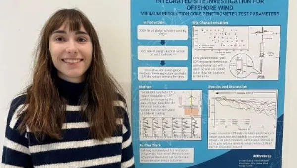 A PhD student in front of her poster