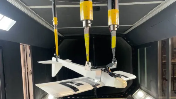 A model aircraft hangs inverted inside a wind tunnel at the University of Southampton.