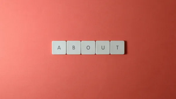 The word About on a brick-coloured background
