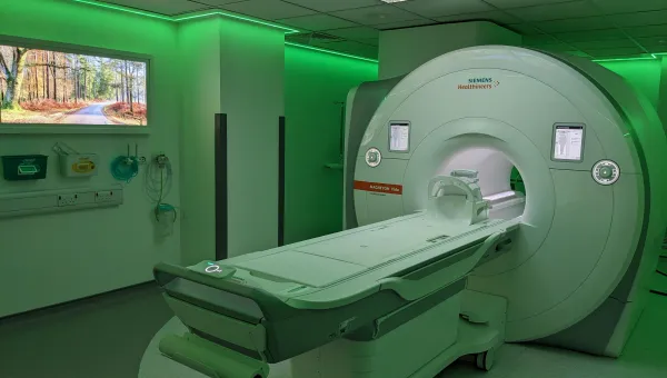 An MRI scanner bathed in green light