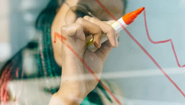 A person drawing a chart on a whiteboard