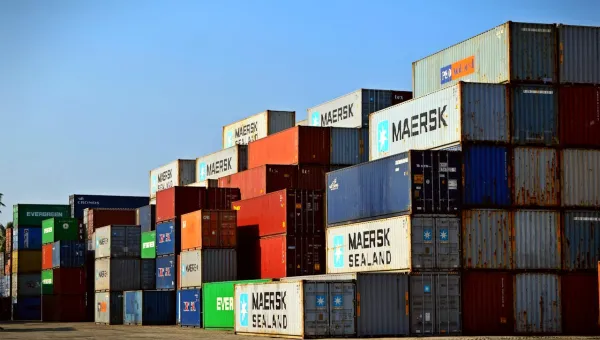 Stack of shipping containers with blue sky overhead