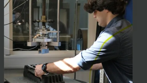 Researcher conducting a laboratory test using specialist materials testing equipment