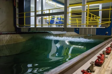 A rogue wave moves along the towing tank, with the carriage sitting above it