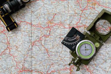 Image of a map and navigational equipment. 
