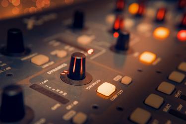 Image of a mixing desk in a recording studio.