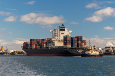 Image of a large container ship carrying shipping containers.