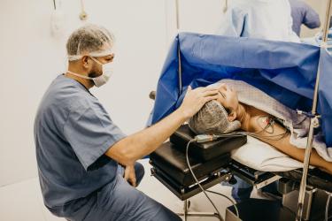 Image of a nurse looking after a patient during surgery. 