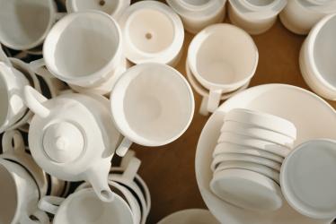 Image of lots of different plates, bowls and cups all in white.