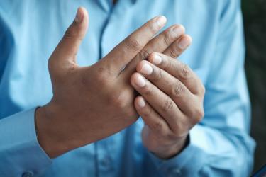 Image of a person rubbing their hands.