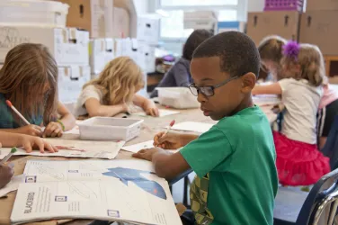 young children drawing and writing and school