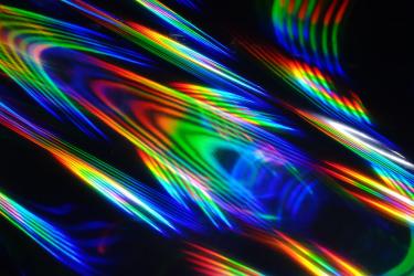 Holographic patterns of light against a black background