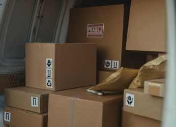 Pexels image of brown parcels stacked inside a delivery van