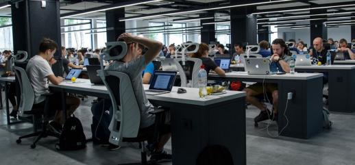 Workers in a digital technology company working in an open-plan office space