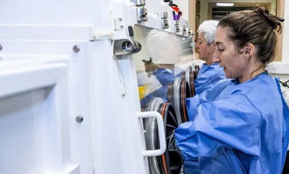 Staff using containment protection equipment