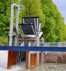 A modern water wheel on a small river