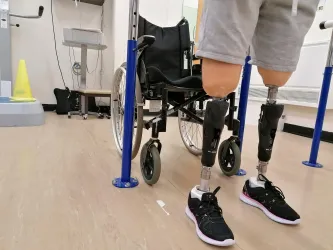 Patient wearing prostehtics infront of wheelchair