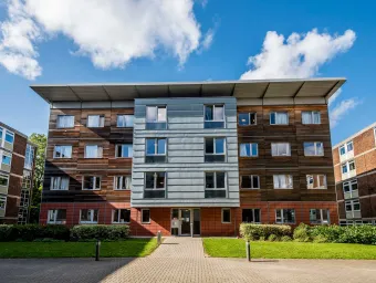 Exterior shot of modern apartment building on a sunny day.