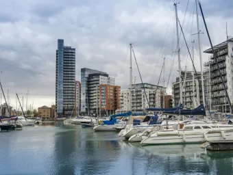 Yachts in Ocean Village Marina, showing skyline on a cloudy day. 
