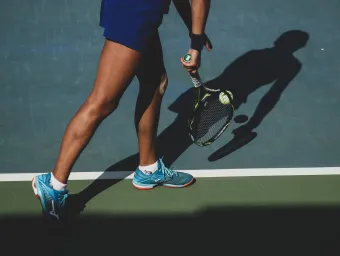 Tennis player preparing to serve