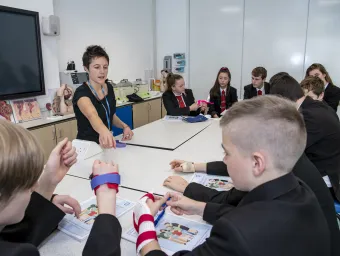 Teaching explaining part of a health lesson to school pupils