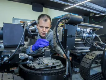An academic uses a piece of equipment in the mu-VIS X-ray imaging centre.