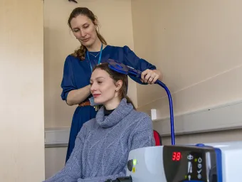 A person using neurostimulation lab equipment