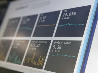 Business analytics visible in foreground of angled computer screen