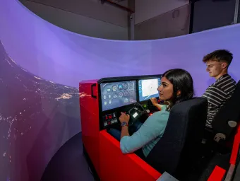2 students use the flight simulator