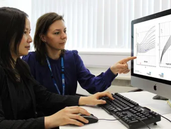 Clinical data researchers compare graphs on a computer screen