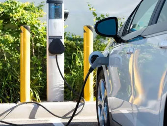 An electric car refuels at a charging point