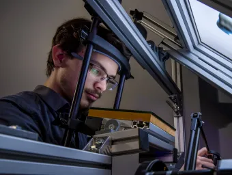 A research student uses equipment in the visual haptic lab