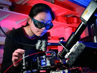 Person in laboratory using laser equipment