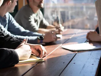 People round a table in a meeting