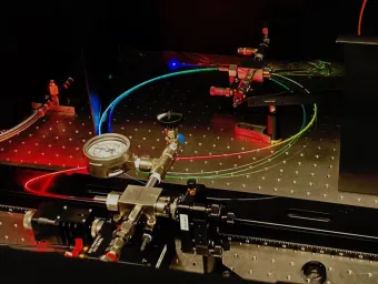 A gas-filled hollow core optical fibre scatters a spectrum of colours. 