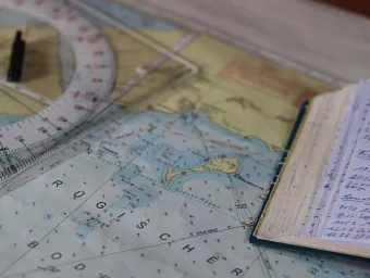 Nautical chart and a notebook on a table