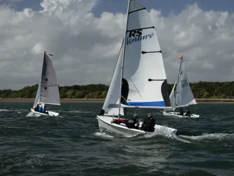 3 dinghies sailing along the coast