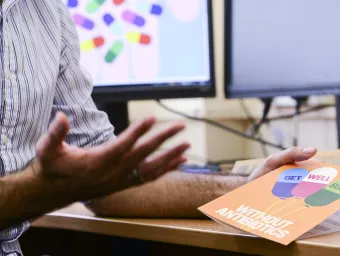 A hand holding a get well without antibiotics card