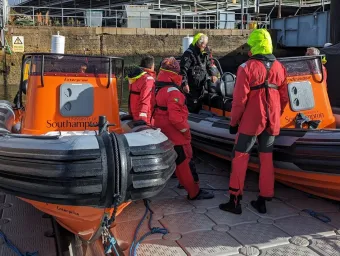 Course instructor and participants looking at 2 powerboats